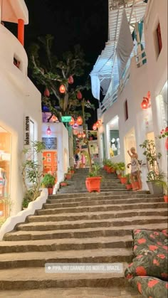 the stairs lead up to an area with potted plants on each side and lanterns hanging from the ceiling