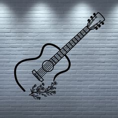 an acoustic guitar is shown against a brick wall