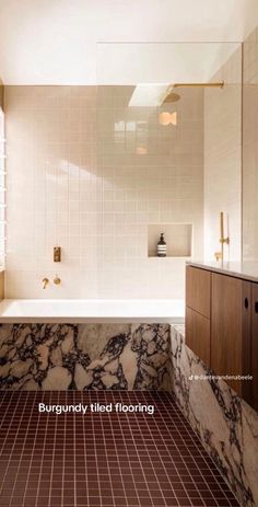 a bathroom with marble floors and tile walls