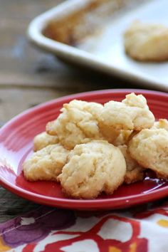 some cookies on a red plate next to baking pans