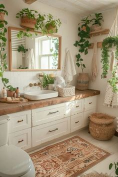 a bathroom with plants hanging on the wall and rugs in front of the sink