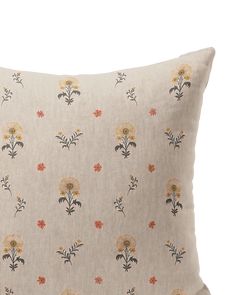 an embroidered pillow with flowers on it