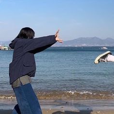 a man is flying a kite on the beach