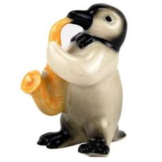 a figurine of a penguin playing the trumpet