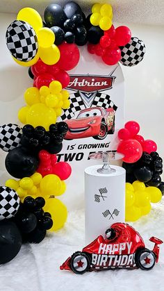 cars birthday party decoration with balloons and streamers