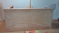 an unfinished wooden counter with colored dots on it