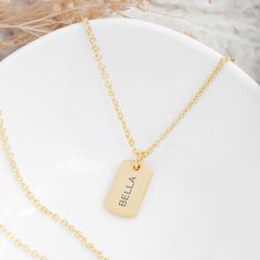 Whatever the occasion, make her feel extra-special with our sensational Personalised Gold Name Tag Necklace. It's a truly one-of-a-kind accessory that she'll wear out whenever she gets the chance and cherish forever.  Whether you want to celebrate a birthday, commemorate a special anniversary or treat her to a Christmas surprise, this outstanding piece of jewellery allows you to add a sentimental touch that speaks straight to her heart. It's also a perfect Valentine's gift to show her how much s Name Tag Necklace, Watch Locket, Watch Cufflinks, Christmas Surprise, Jewelry Lockets, Valentine's Gift, Childrens Jewelry, Name Tag, Name Tags