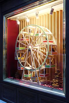 a ferris wheel sitting inside of a store window