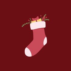 a red christmas stocking with green leaves sticking out of it's side on a maroon background