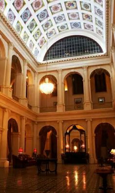 an ornately decorated lobby with chandeliers and tables