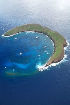 an aerial view of the island with boats in the water and on top of it