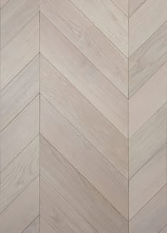 an image of wood flooring that looks like herringbones or chevron boards