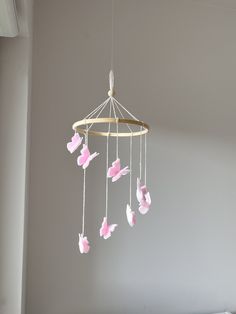 a mobile with pink flowers hanging from it