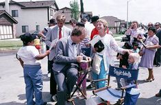 a group of people standing and sitting around each other