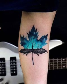 a tattoo with a blue leaf on it