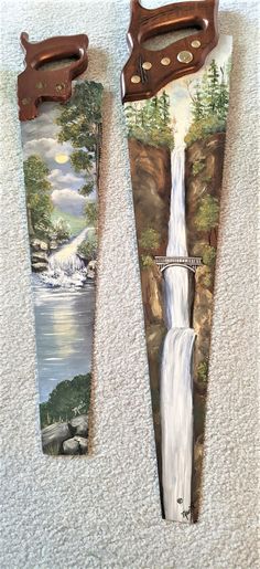 two wooden skis with paintings on them