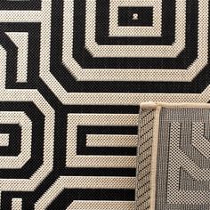 an area rug with black and white designs on it