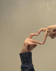 two hands making a heart shape with their fingers