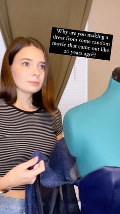 a woman standing next to a dress on a mannequin with a thought bubble above her head