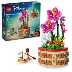 a lego flower pot with flowers in it next to a box and toy figure set