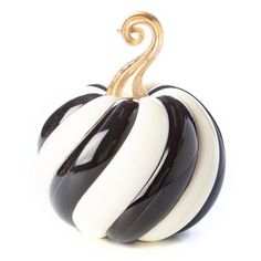 a black and white striped pumpkin sitting on top of a table