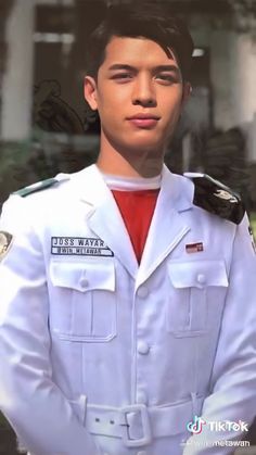 a young man in uniform is posing for a photo