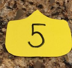 a yellow sticker with the number five on it