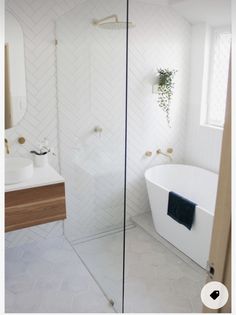 a bathroom with a tub, sink and shower in it's own area is shown