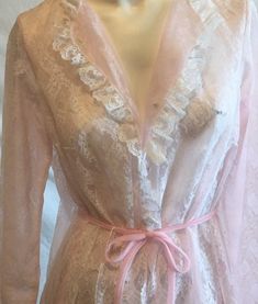 Found this at an estate sale. The women had many many many pieces of unworn lingerie. This is a piece by Miss Elaine. Sized as small but runs large. Chiffon base layer over a full lace cover. Ruffled sleeves and neck line. Tie waist.Lace covered buttons. Measures bust 38'' length 57'' Vintage Lace Trim Robe For Spring, Vintage Spring Robe With Lace Trim, Spring Vintage Robe With Lace Trim, Vintage Spring Robe For Home, Vintage Daywear Robe With Lace Trim, Vintage Sheer Sleepwear, Vintage Long Robe For Daywear, Long Vintage Robe For Daywear, Vintage Lace Sleepwear With Delicate Detail