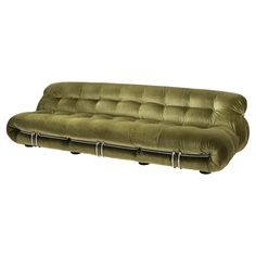 a green couch sitting on top of a white floor