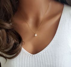 "A timeless classic that celebrates the beauty of minimalism on an 18k gold over 925 sterling silver box chain. The freshwater pearl measures a dainty 6mm and comes 16\" with a 2\" extension chain. This delicate piece whispers sophistication and grace, making a statement that is both subtle and impactful.  The Single Pearl Necklace is a symbol of purity, wisdom, and cherished connections - an expression of appreciation that transcends words. ✦ 18K Gold plated 925 Sterling Silver Chain ✦ Freshwater Pearl / 6mm ✦ Comes 16\" with a 2\" extension WHY YOU'LL LOVE IT * Because handmade = made with love, care, and thought. * Ethically Sourced * Comes beautifully gift boxed * Crafted with care from sunny South Florida.   HAPPINESS GUARANTEE: We stand by our jewelry and want you to love it too! GIF Barn Dance, Single Pearl Necklace, Pearl Gifts, Single Pearl, Silver Pearl Necklace, Freshwater Pearl Necklace, Silver Box, 925 Sterling Silver Chain, Gift For Girlfriend