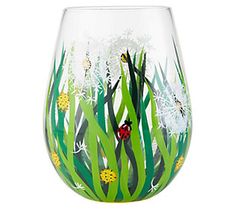 a glass vase with grass and ladybugs painted on it