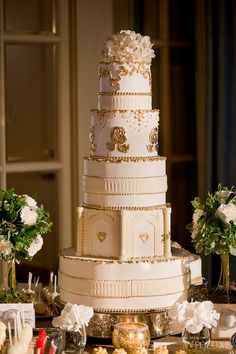 a large white wedding cake sitting on top of a table next to other desserts