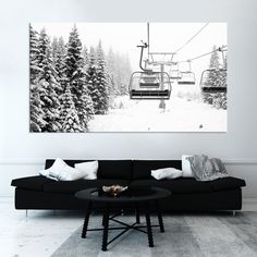 a living room with a black couch and a ski lift