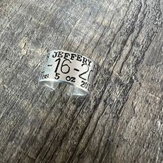 a close up of a ring on top of a wooden table with the numbers fifteen and twenty