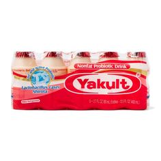 four bottles of yakult drink on a white background with the word yakul written in chinese