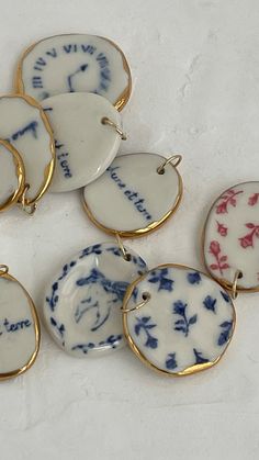 five porcelain pendants with writing on them