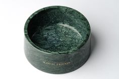 a green marble bowl sitting on top of a white table