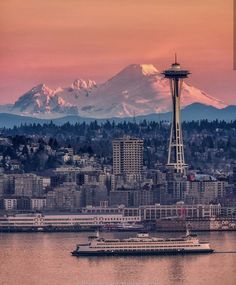 the space needle in seattle, with mount rainier in the background