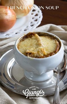 french onion soup in a white bowl on a silver plate