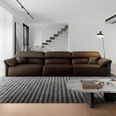 a living room filled with furniture and a stair case