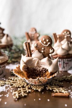 some cupcakes with frosting and cinnamon on top are sitting on a table