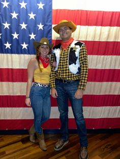 a man and woman dressed up in cowboy outfits standing next to an american flag background