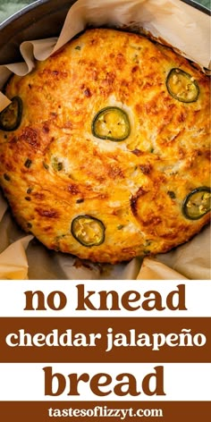 a close up of a pizza in a pan with the words no knead cheddar jalapeno bread