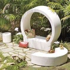 an outdoor seating area in the middle of a garden