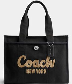 From COACH&#x2C; the Large Cargo Tote 42 Bag features:Canvas&#x2C; grosgrain&#x2C; and recycled leatherZip-top closureFabric liningOutside turn-lock and snap pocketsFits a 16" laptopHandles with 9" dropApprox.: 16.25" L x 12.25" H x 7.75" WImported. Large Coach Tote Bag, Coach Travel Bag In Canvas, Coach Canvas Travel Bag, Coach Tote Shoulder Bag With Large Capacity, Coach Tote Shoulder Bag With Removable Pouch, Coach Cargo Tote, Coach Bags With Large Capacity For On-the-go, Coach Tote Bag, Biological Diversity