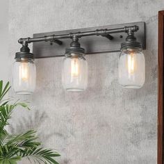 three light vanity fixture with mason jars on it