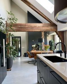 an open kitchen and living room with skylights