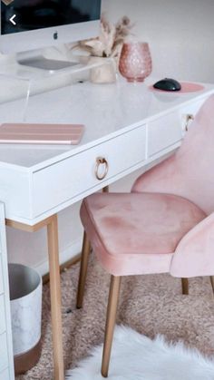 a white desk with a pink chair next to it and a computer monitor on top