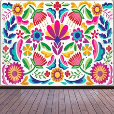 an artistic painting on the wall with flowers and leaves in bright colors is displayed against a wooden floor